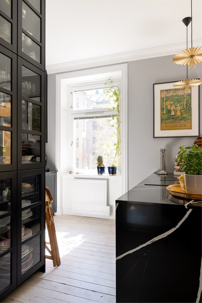A Lovely Stockholm Apartment with a Black Kitchen and Pink Bedroom 9 floor to ceiling glass kitchen cabinet