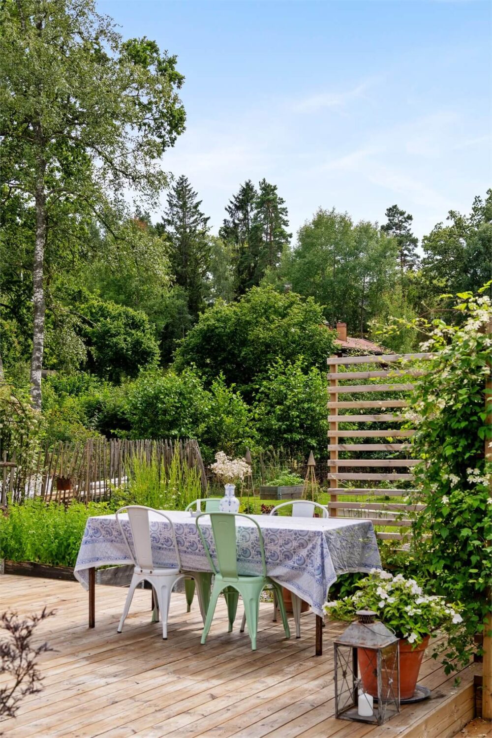 A Bright Open-Plan Swedish Home with a Pink Kitchen 26 garden dining table