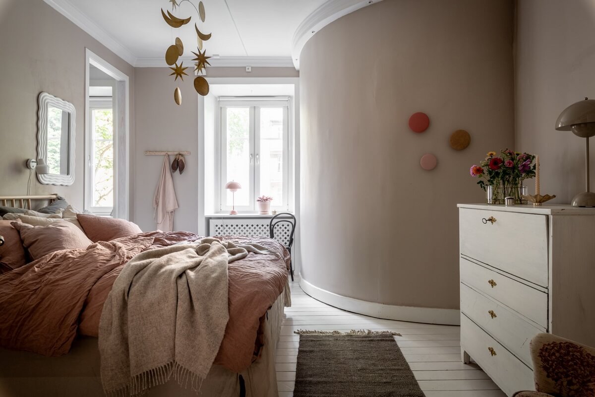 A Scandinavian Apartment with a Pale Yellow Living Room 17 gray bedroom with rounded wall