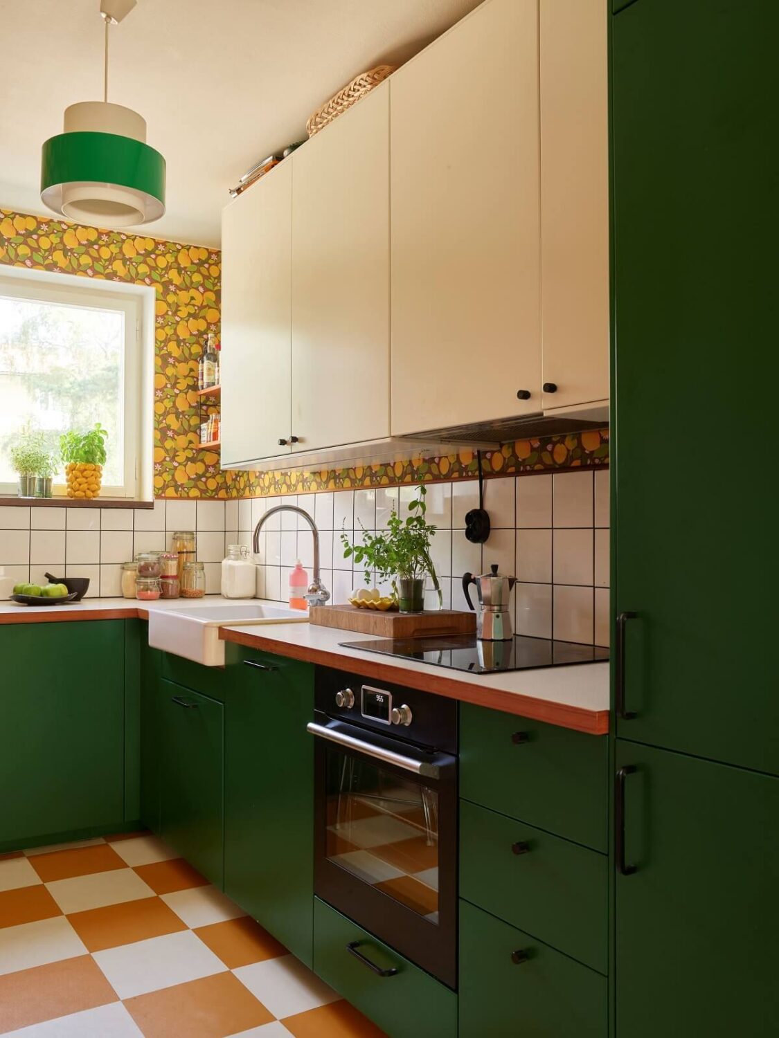 A Colorful Swedish Apartment Inspired by the 50s and 70s 2 green kitchen lemon wallpaper and checkerboard floor nordroom