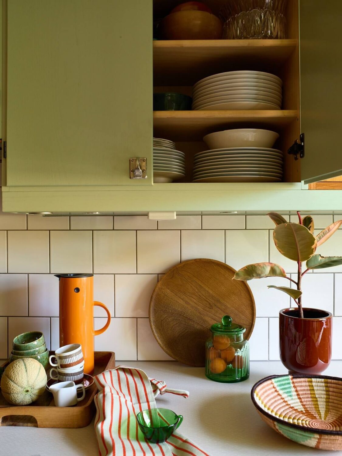 A Charming and Cozy Midcentury Family Apartment in Sweden 14 green midcentury kitchen cabinets nordroom
