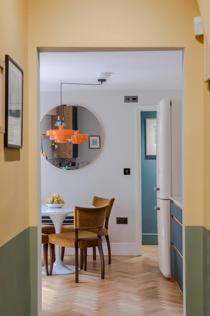 A London Apartment with a Deep Olive Green Kitchen 9 half painted green and yellow hallway nordroom