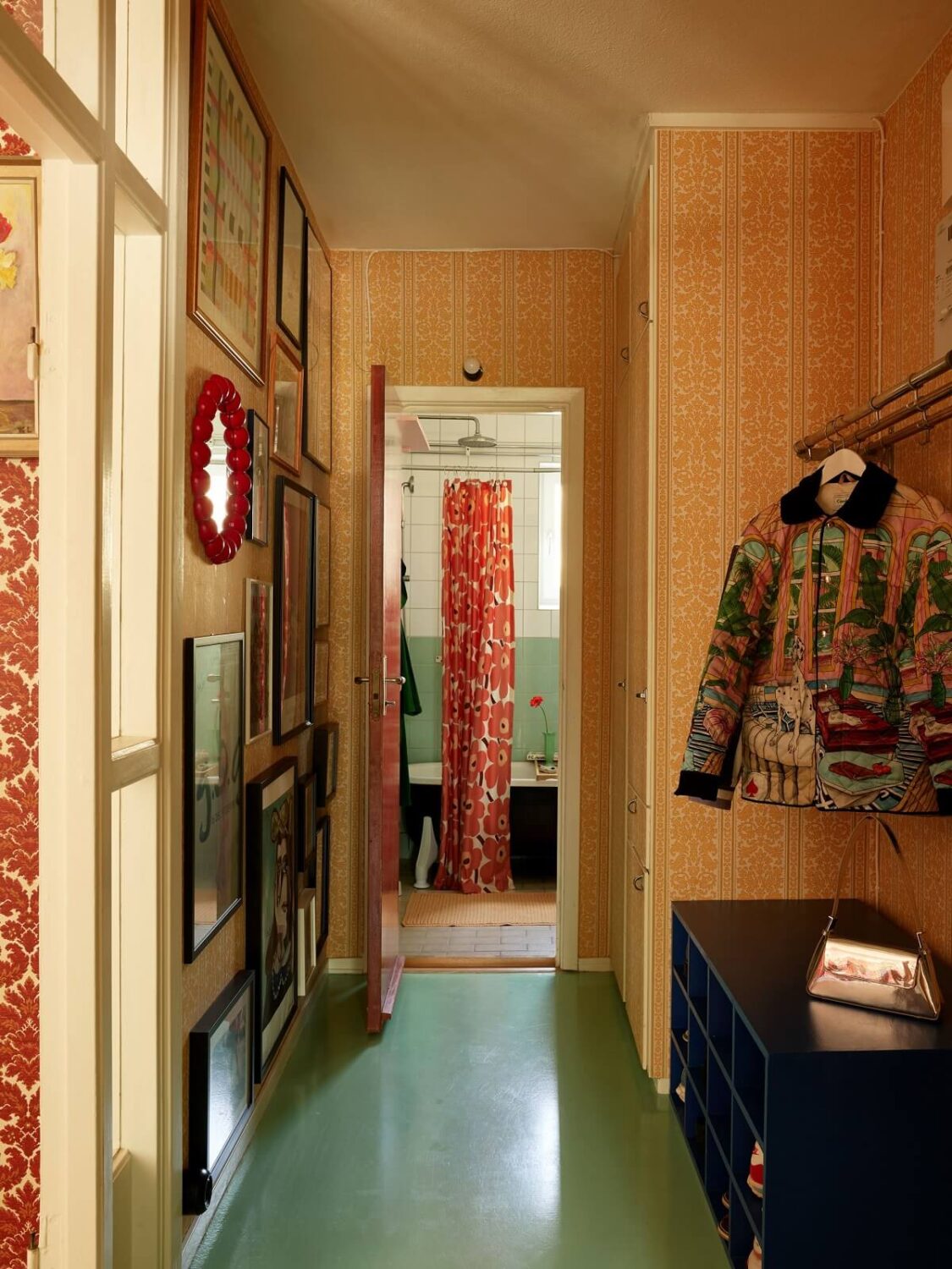 A Colorful Swedish Apartment Inspired by the 50s and 70s 29 hallway mint green concrete floor gallery wall nordroom