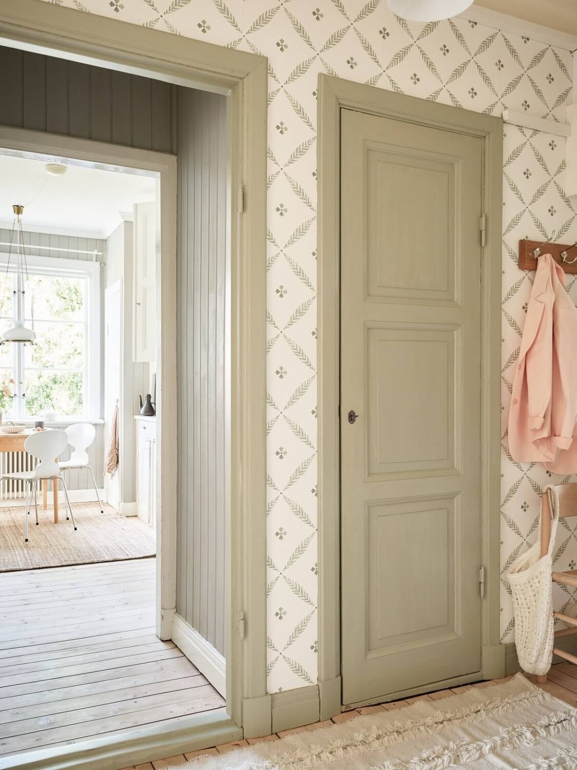 A Light Swedish Apartment with a Charming Kitchen 23 hallway sage green doors wallpaper