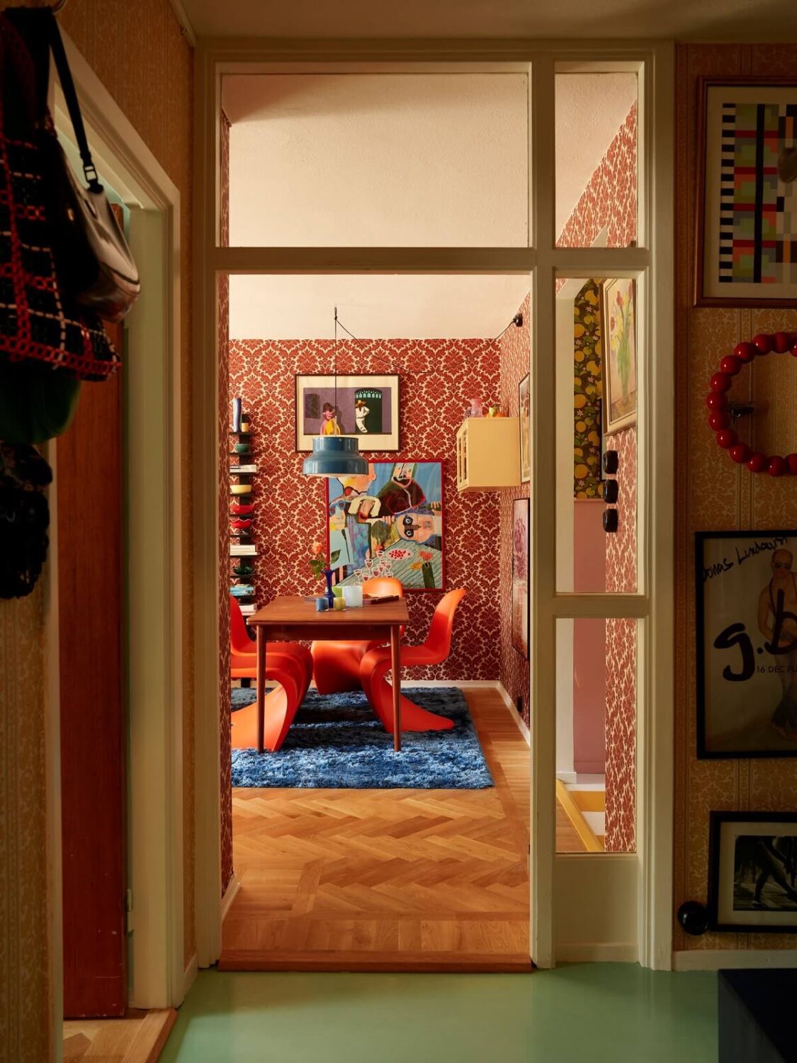 A Colorful Swedish Apartment Inspired by the 50s and 70s 17 hallway view into living room with midcentury doorway nordroom