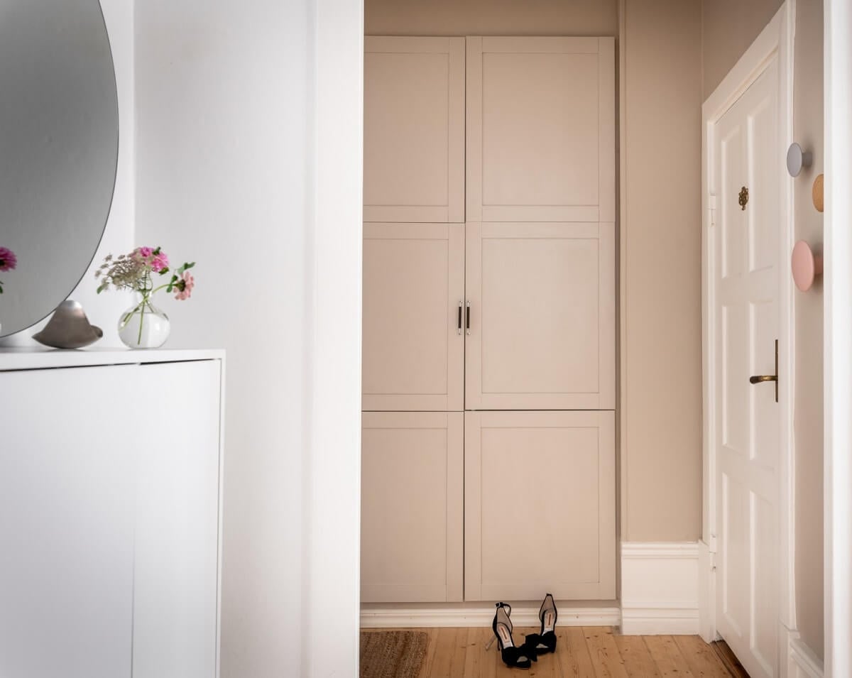 A Scandinavian Apartment with a Pale Yellow Living Room 22 hallway with built in cabinets