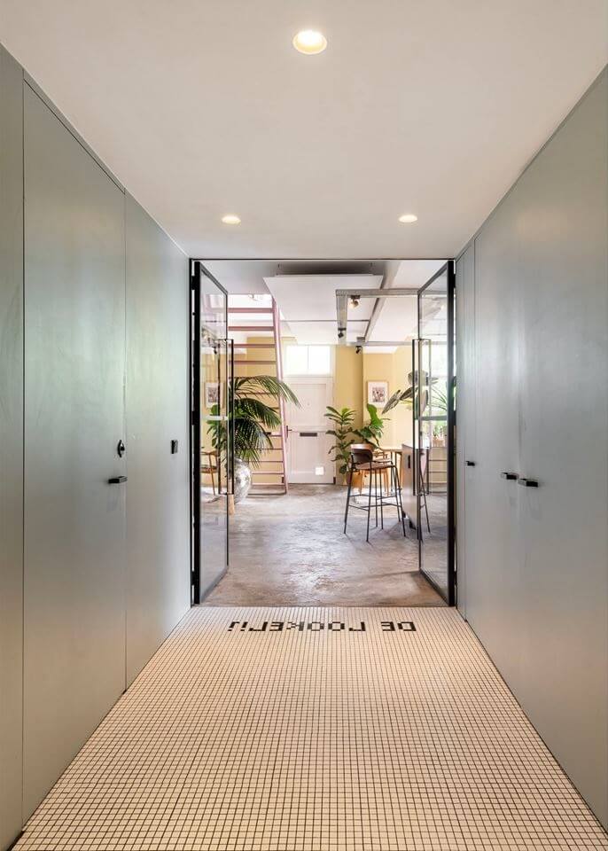An Old Smokehouse Transformed Into a Modern Industrial Home 18 hallway with built in cabinets