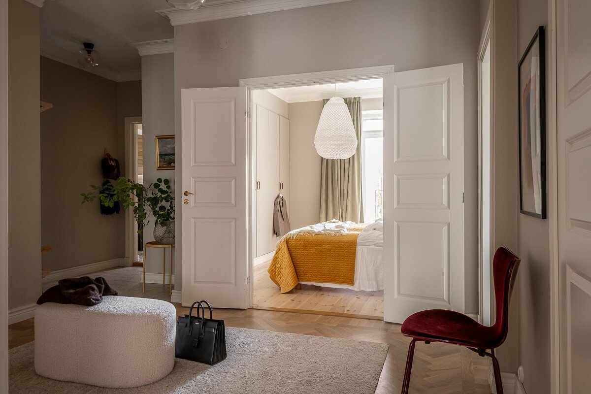 A Spacious Renovated Apartment with a Light Pink Living Room 27 hallway with double wooden doors