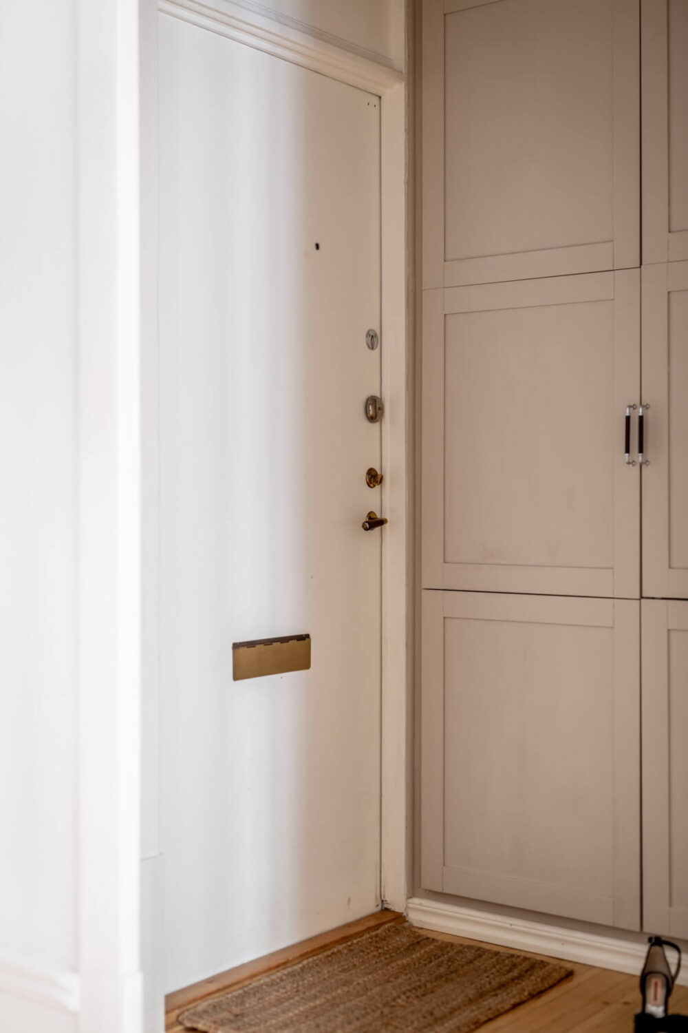 A Scandinavian Apartment with a Pale Yellow Living Room 24 hallway with floor to ceiling cabinet A Scandinavian Apartment with a Pale Yellow Living Room