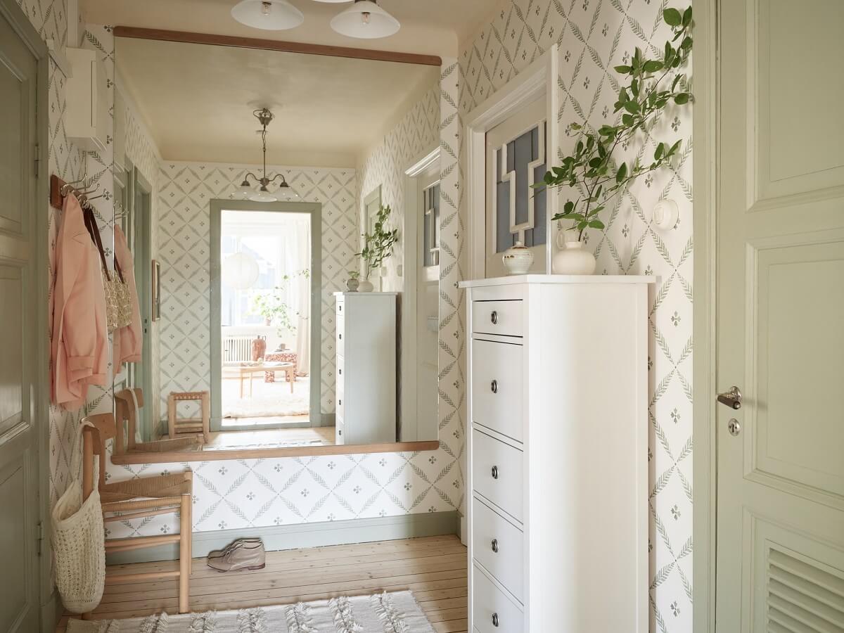 A Light Swedish Apartment with a Charming Kitchen 24 hallway with sage green color accents and wallpaper nordroom