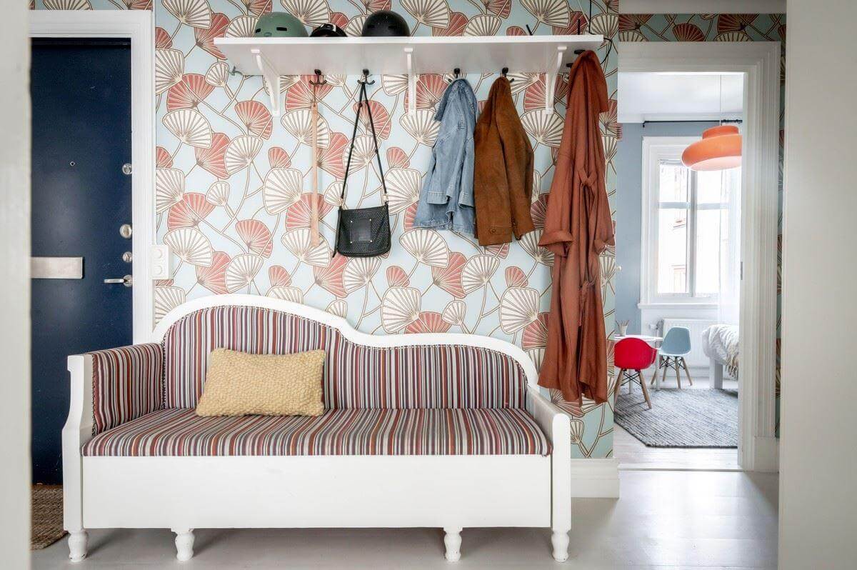 A Bright Swedish Apartment with Subtle Color Accents 13 hallway with striped bench and wallpaper