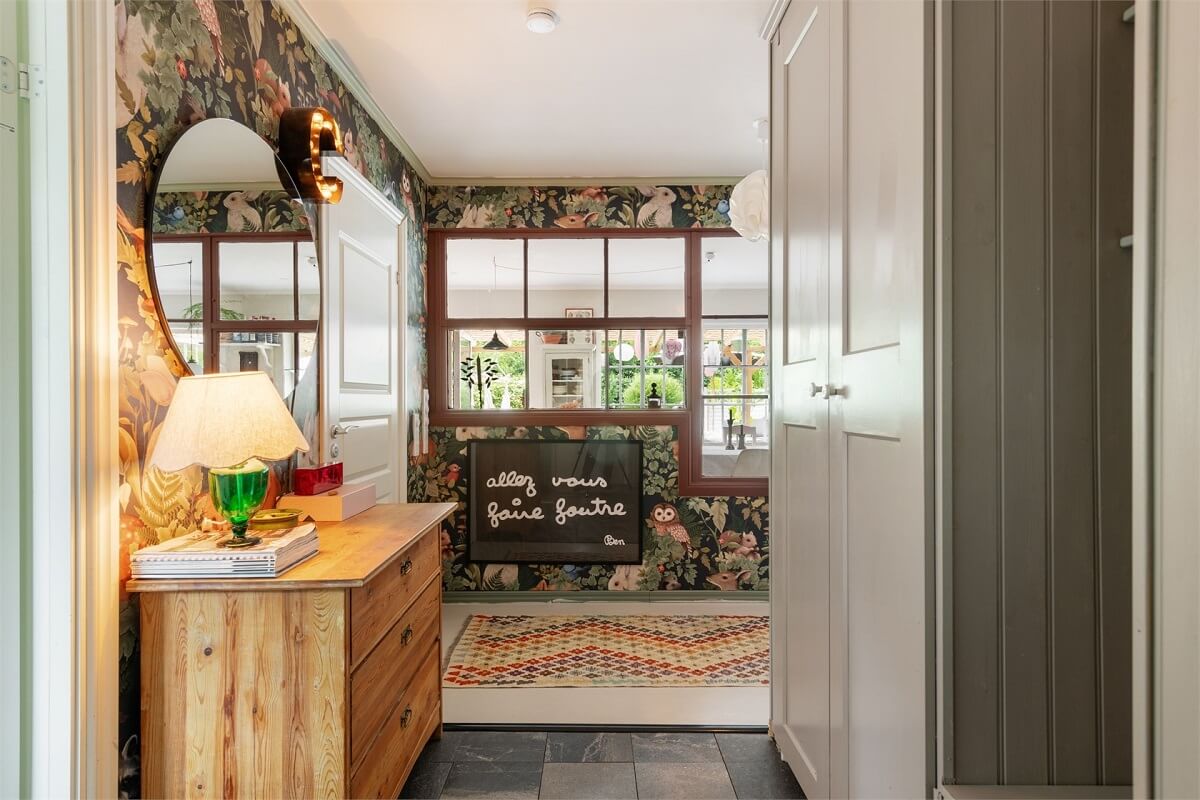 A Bright Open-Plan Swedish Home with a Pink Kitchen 18 hallway with wallpaper