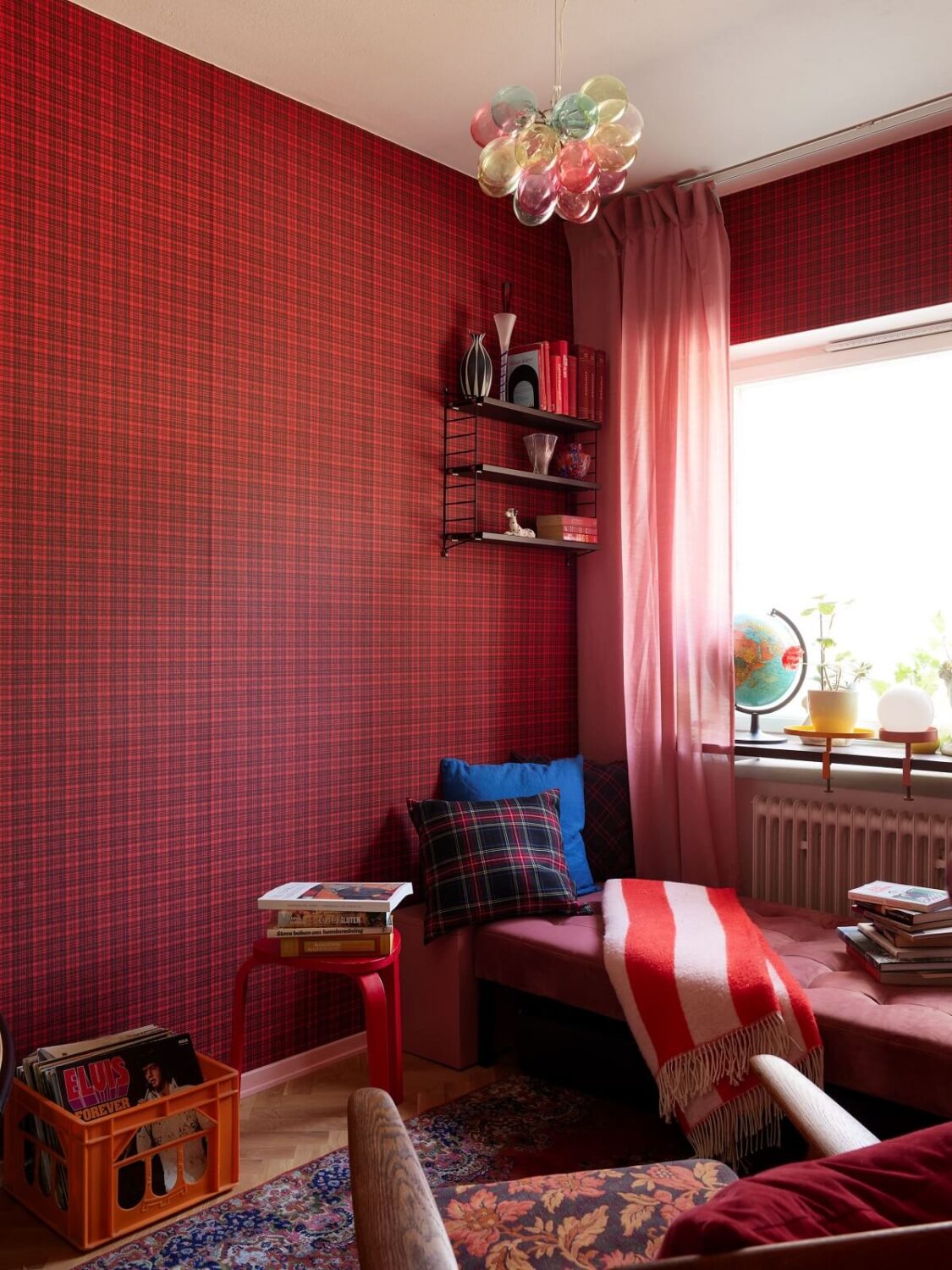 A Colorful Swedish Apartment Inspired by the 50s and 70s 19 home office with red wallpaper and daybed in front of the window nordroom