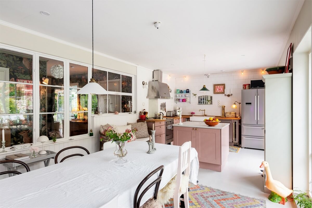 A Bright Open-Plan Swedish Home with a Pink Kitchen 8 kitchen and dining room with glass wall
