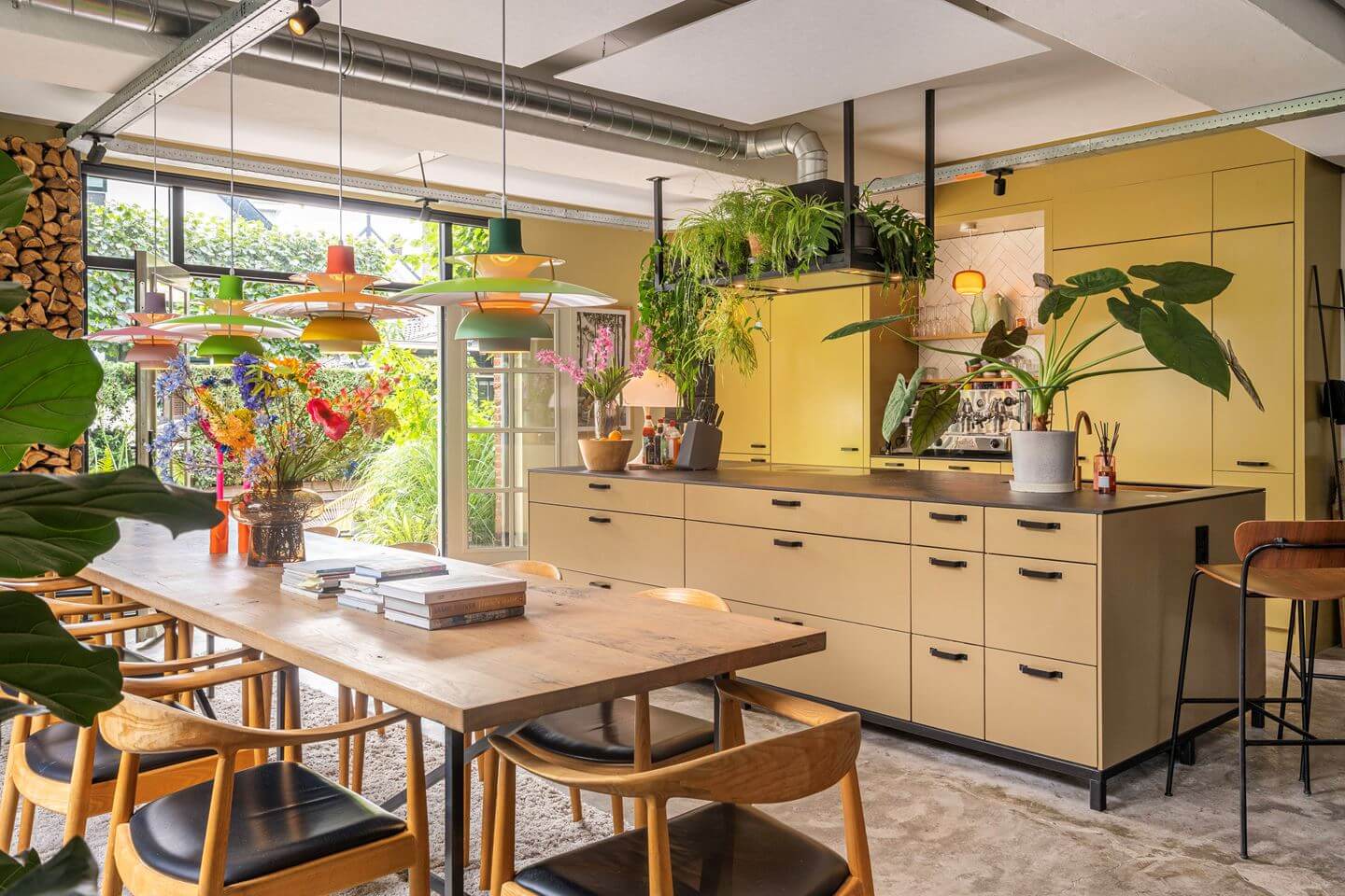 An Old Smokehouse Transformed Into a Modern Industrial Home 10 kitchen dining room with island and yellow cabinets nordroom
