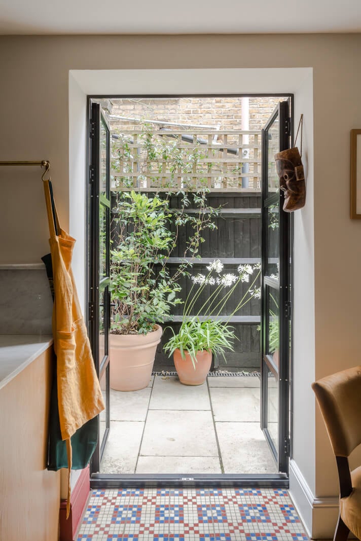A London Apartment with a Deep Olive Green Kitchen 10 kitchen exit to garden