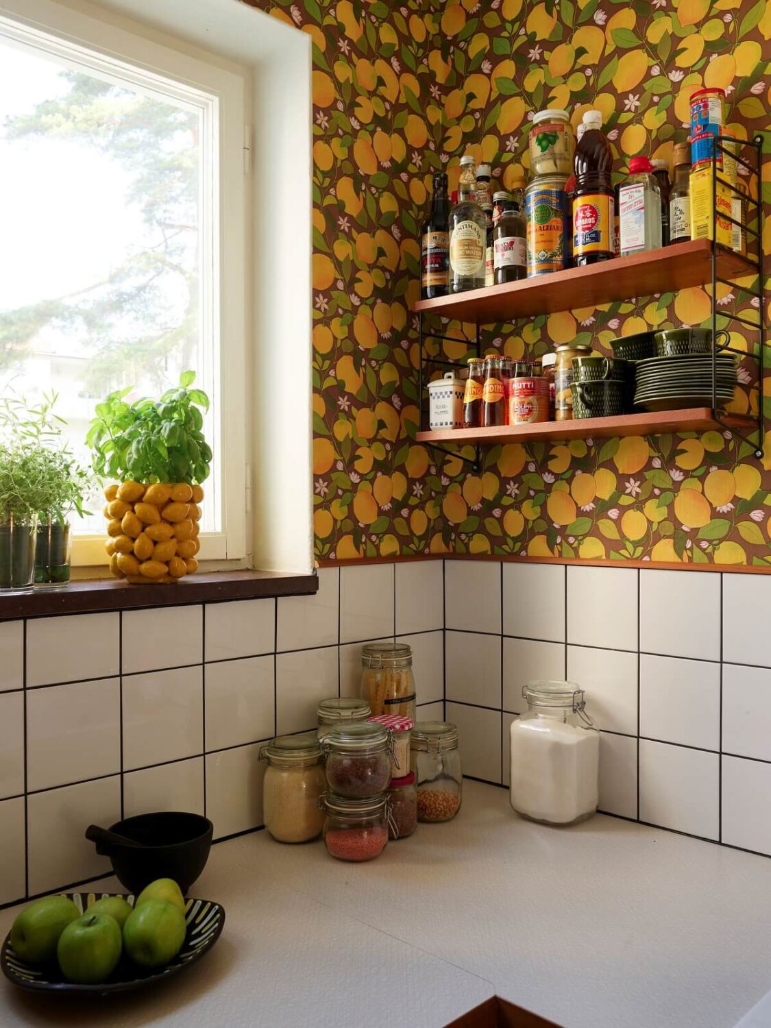 A Colorful Swedish Apartment Inspired by the 50s and 70s 3 kitchen lemon wallpaper nordroom