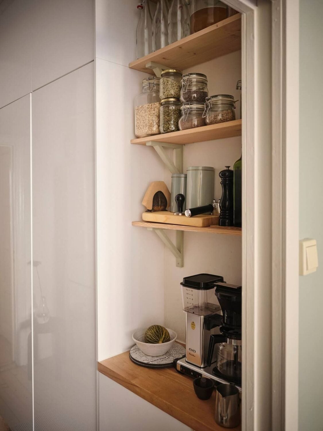 Muted Gray, Green, and Yellow Walls in a Stockholm Apartment 11 kitchen shelves