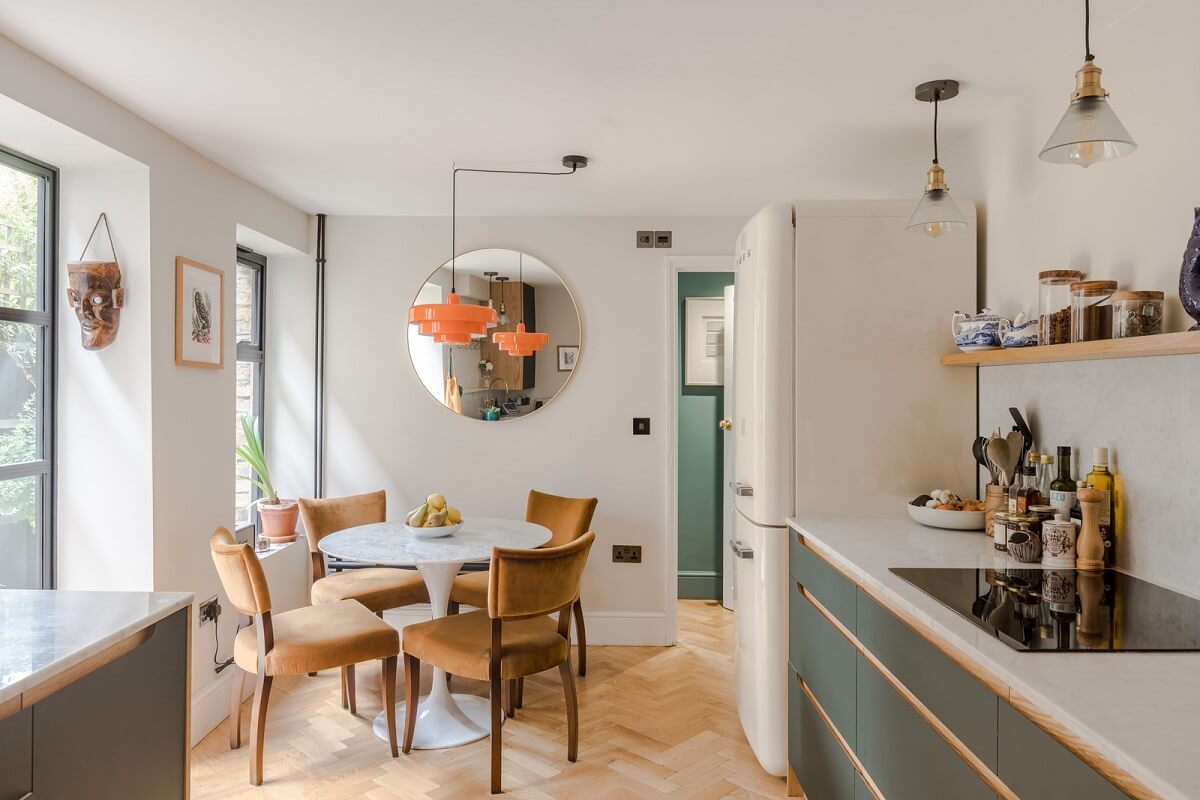 A London Apartment with a Deep Olive Green Kitchen 4 kitchen with deep olive green cabinets shelf and round dining table nordroom