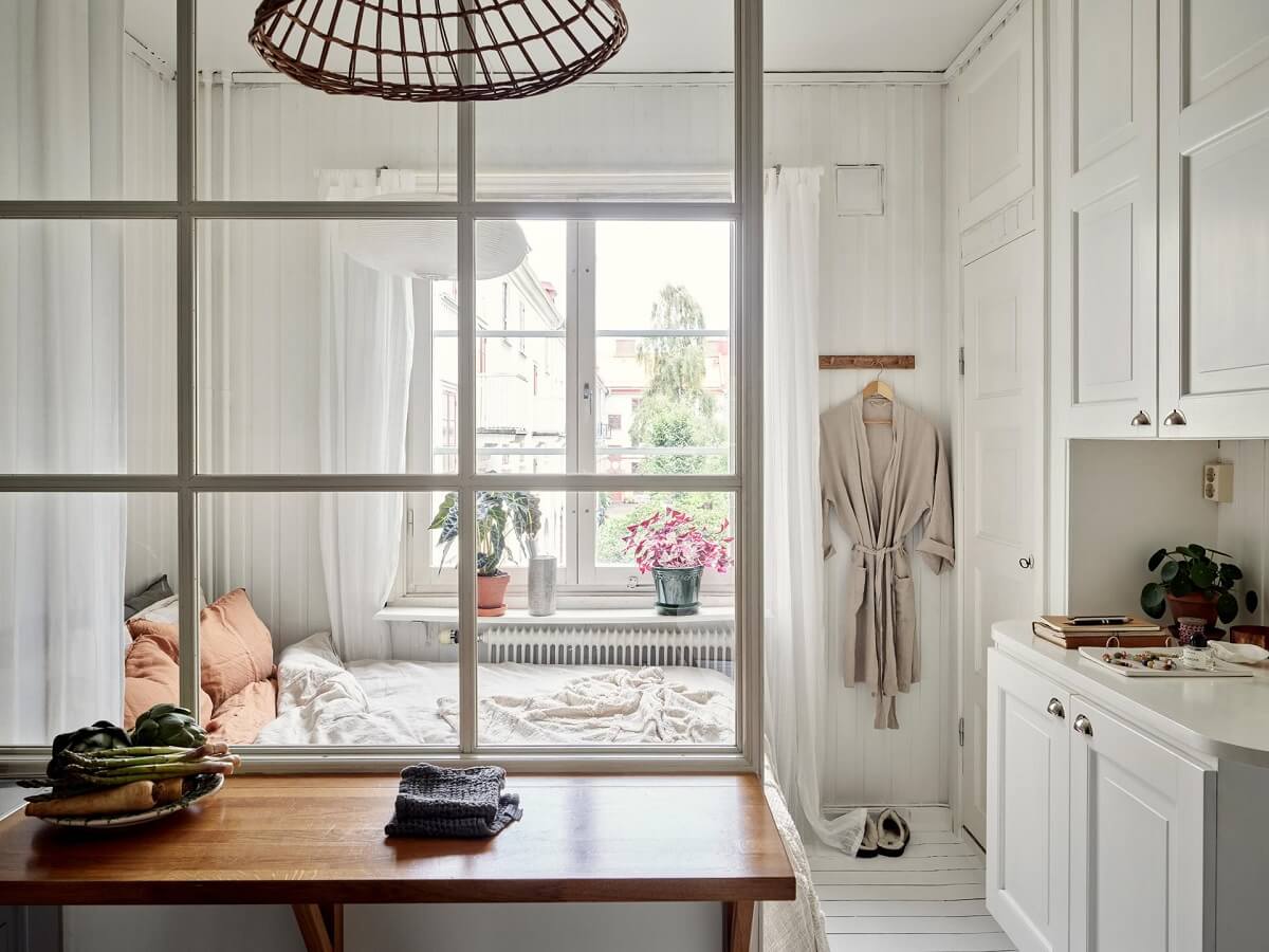 A Small Apartment with a Bright Open-Plan Kitchen & Bedroom 5 kitchen with glass wall to bedroom