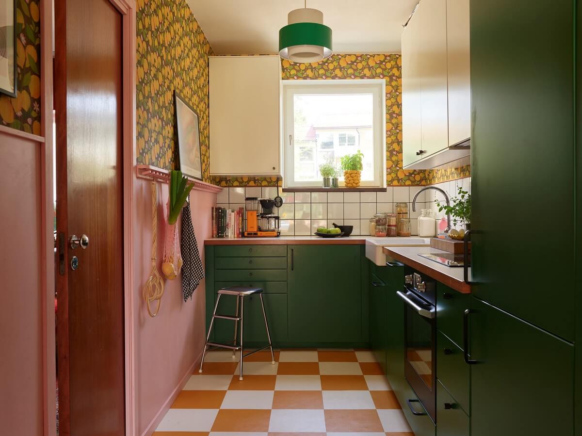 A Colored Sixth Wall May Be The Biggest Paint Trend in 2026 13 kitchen with green cabinets lemon wallpaper checkerboard floor and pink half wall nordroom