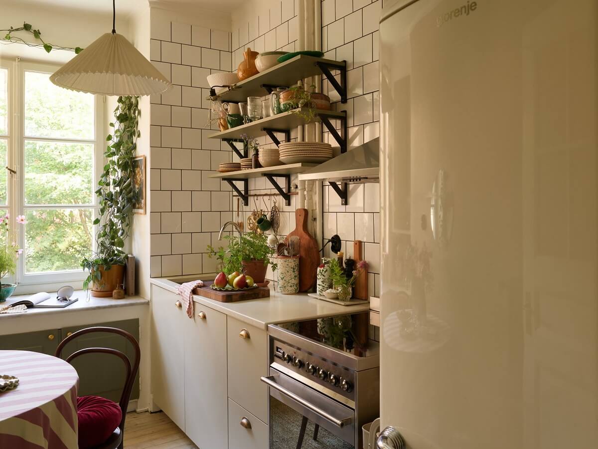 A Cozy 1920s Apartment with Original Details and Wallpaper 16 kitchen with green painted shelves nordroom
