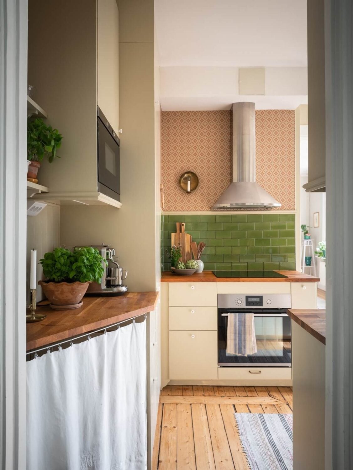Charming Vintage Country Style in a Family Apartment in Sweden 14 kitchen with green tiles and wooden floor