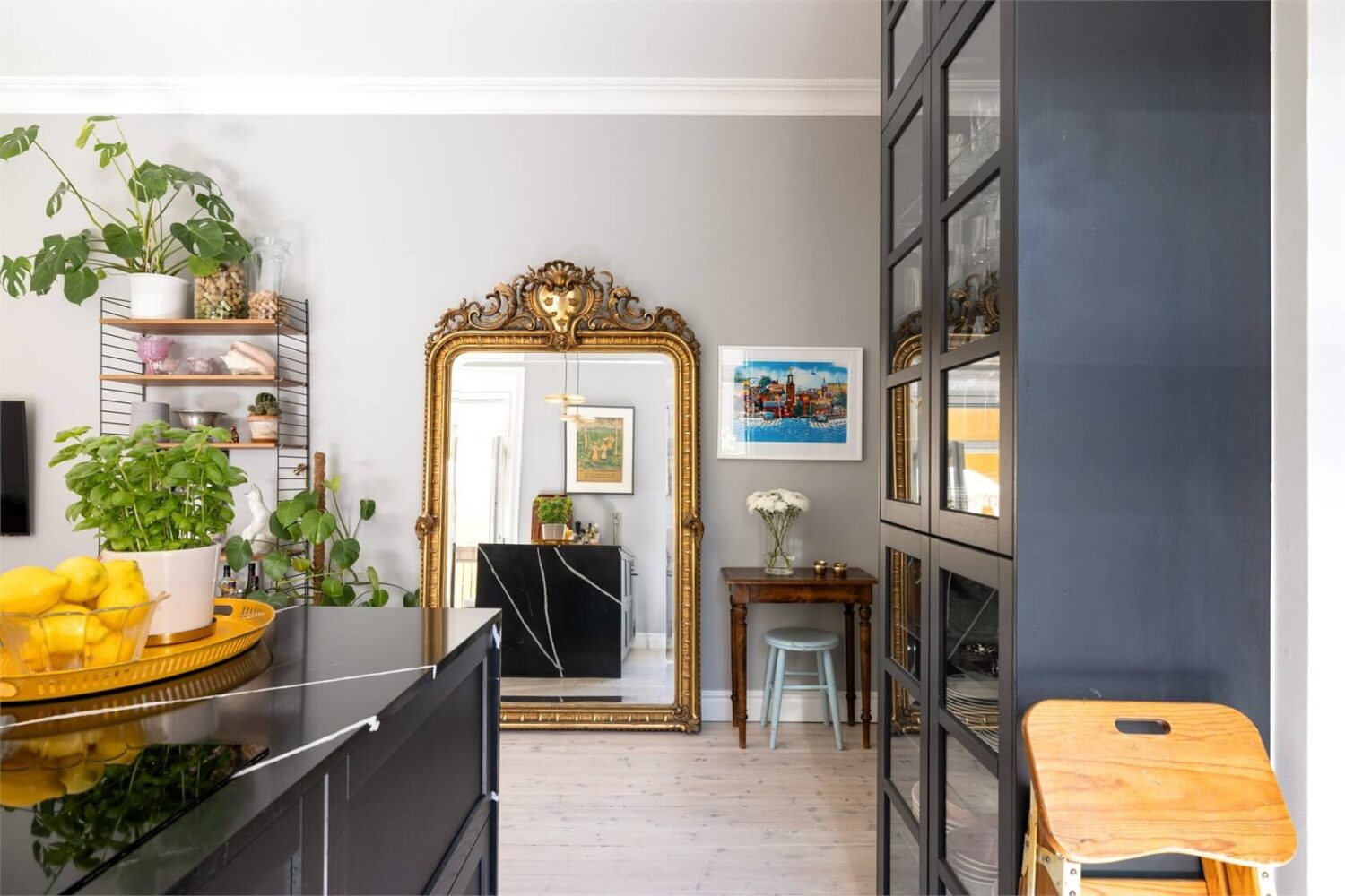 A Lovely Stockholm Apartment with a Black Kitchen and Pink Bedroom 6 kitchen with large gilded mirror