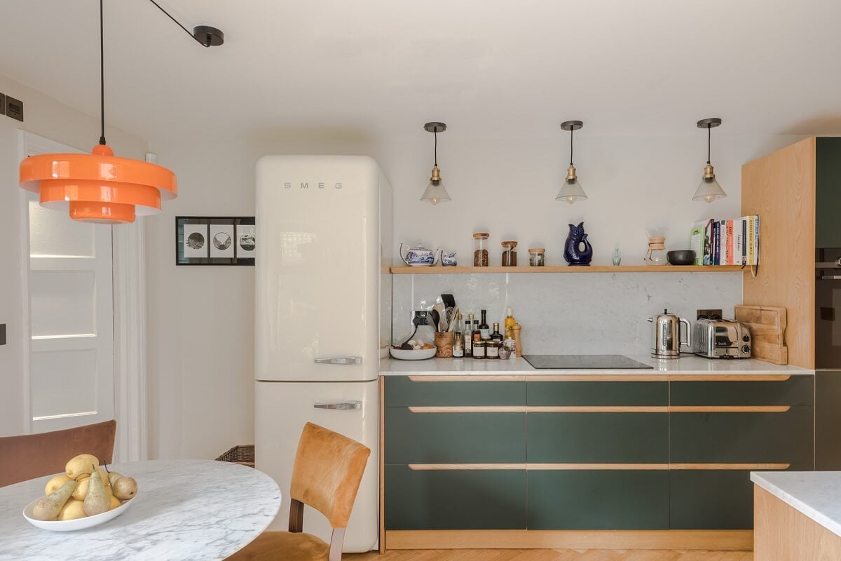 A London Apartment with a Deep Olive Green Kitchen 5 kitchen with olive green cabinets and shelf nordroom