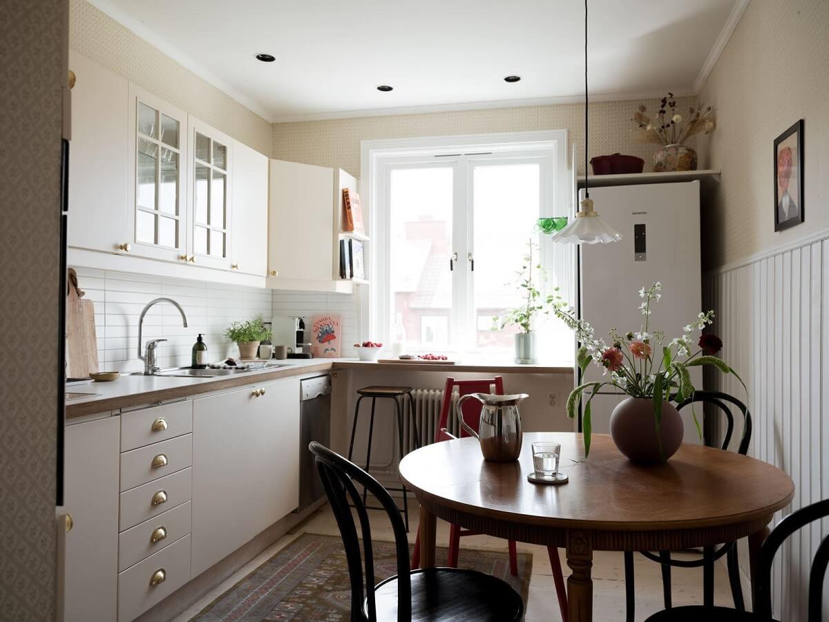 A Beautiful Renovated Maisonette Home with a Calm Color Palette 10 kitchen with round wooden table