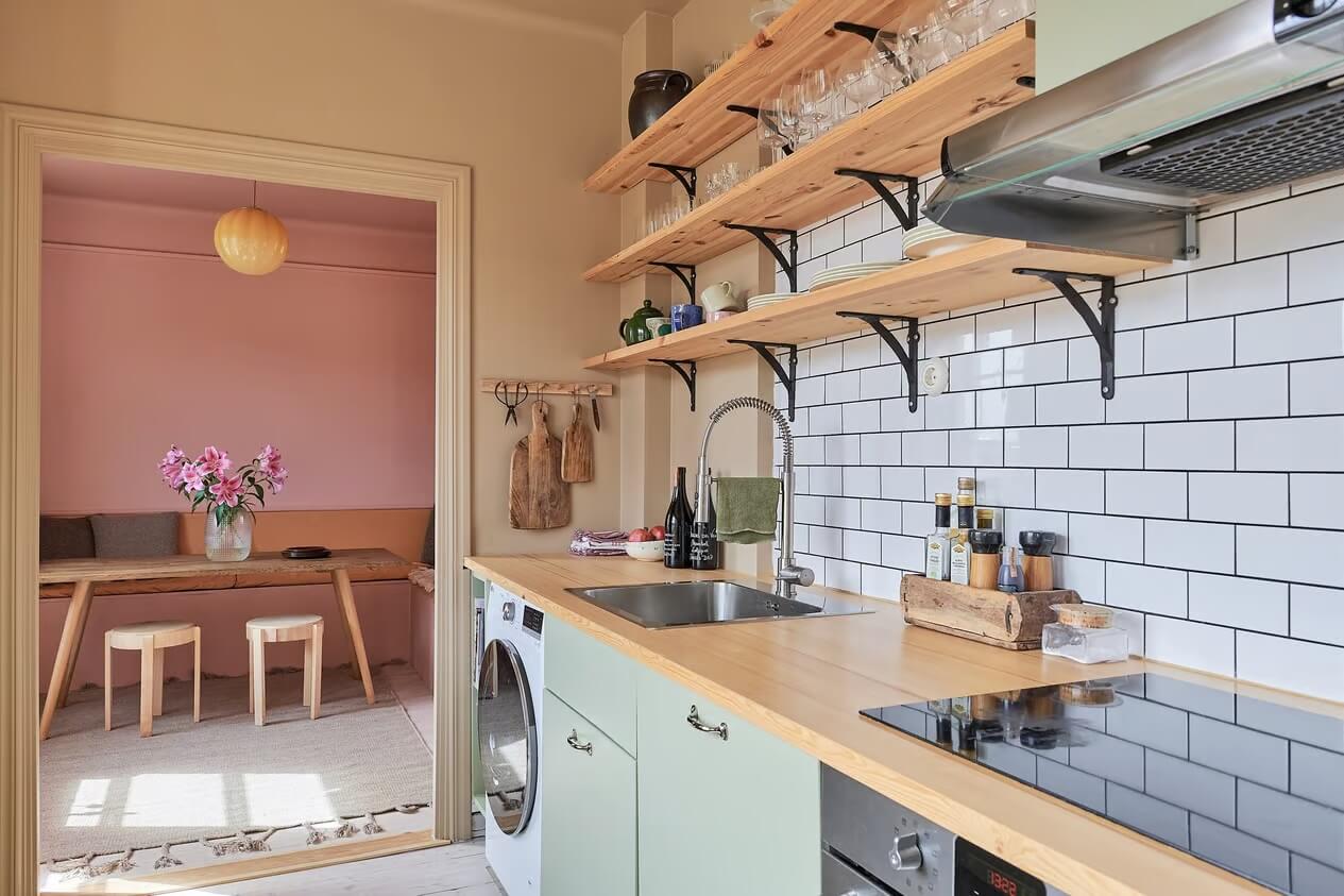 Warm Color-Drenched Rooms in a Swedish Apartment 10 kitchen with subway tiles shelves