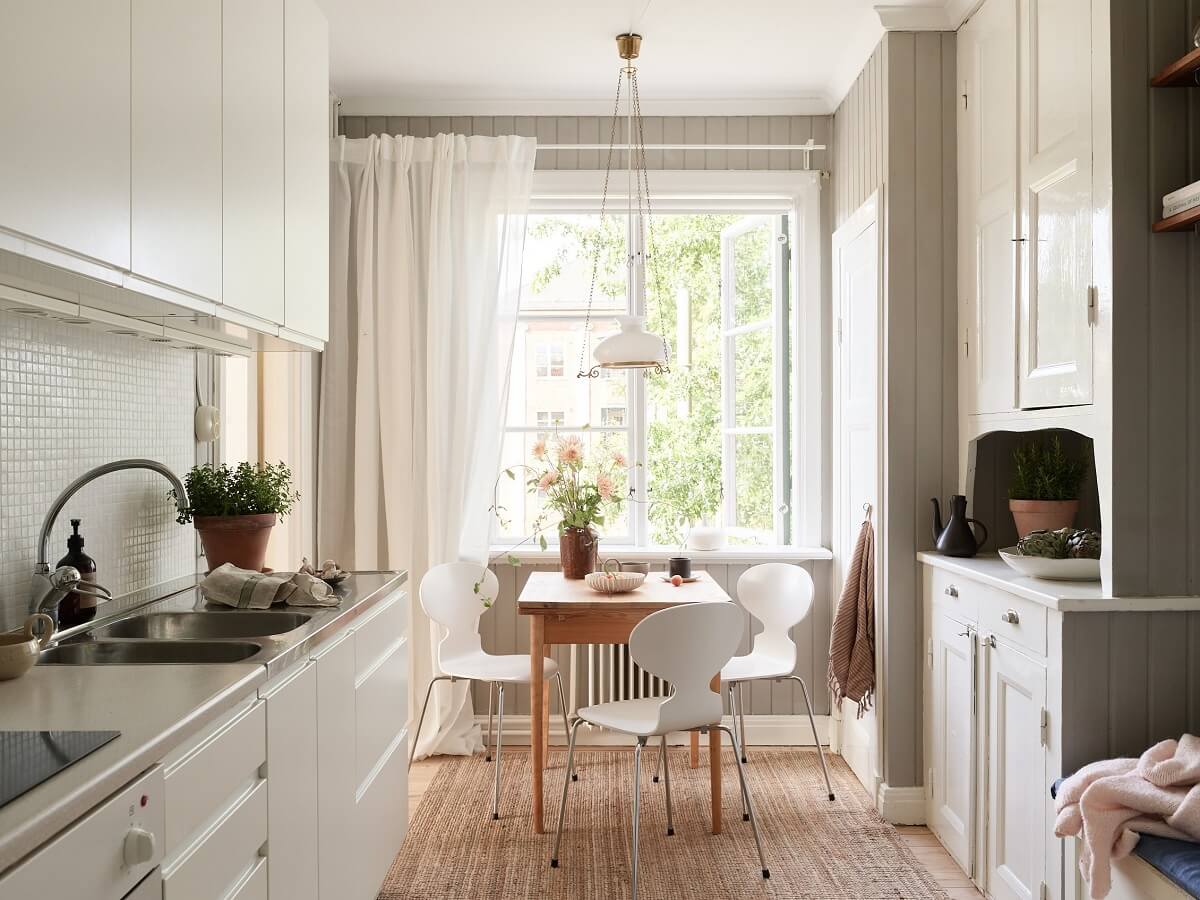 A Light Swedish Apartment with a Charming Kitchen 5 kitchen with white cabinets and original cupboards