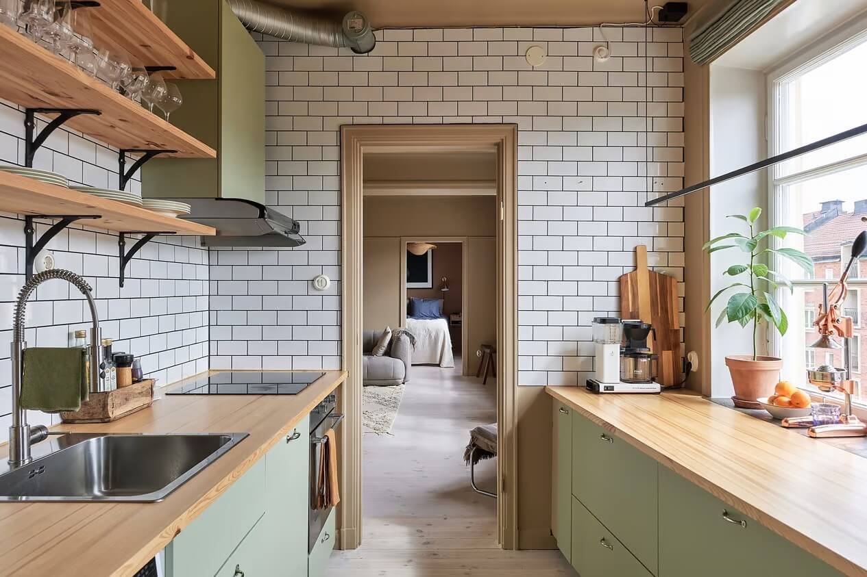 Warm Color-Drenched Rooms in a Swedish Apartment 11 kitchen with white subway tiles to ceiling