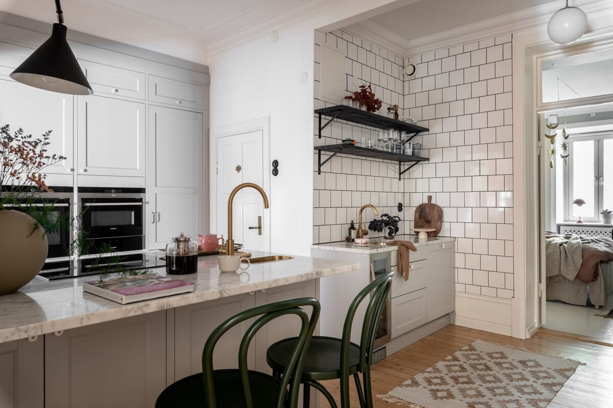 A Scandinavian Apartment with a Pale Yellow Living Room 15 kitchen with white tiles