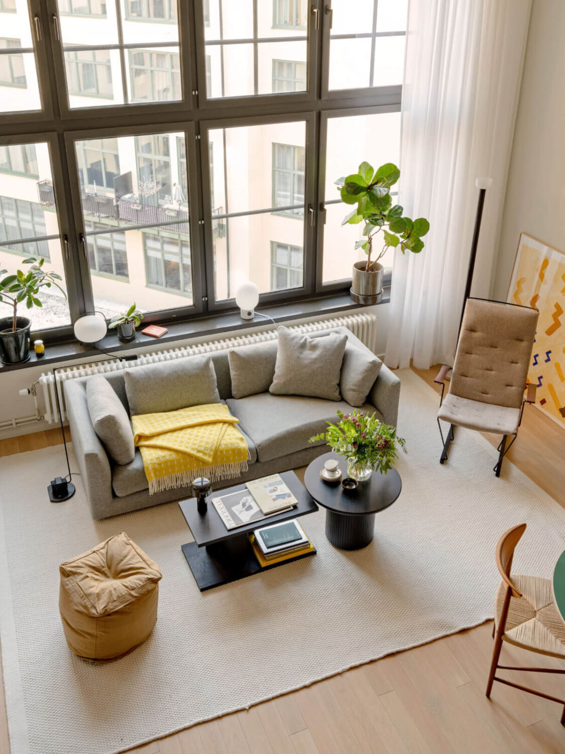 A Monochrome Loft with High Ceilings and Art 12 large rug high windows loft living room A Monochrome Loft with High Ceilings and Art