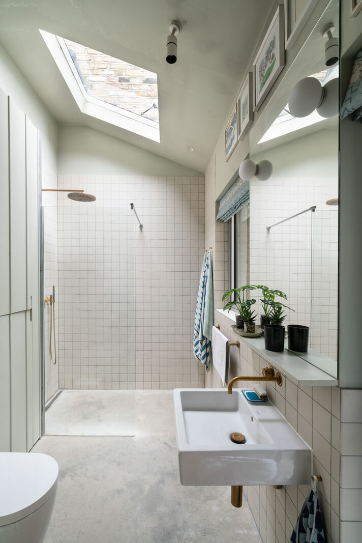 A Beautiful London Family Home with Colorful Accents 19 light bathroom with skylight above shower nordroom