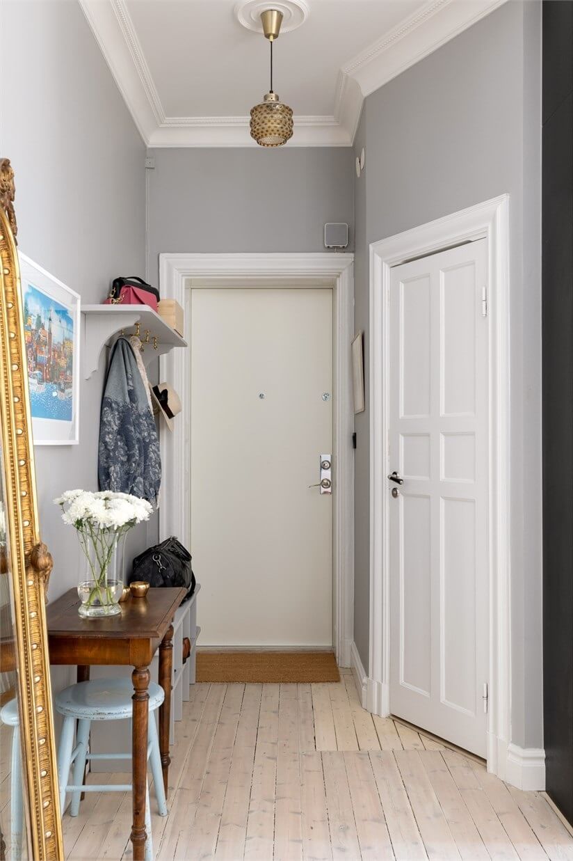 A Lovely Stockholm Apartment with a Black Kitchen and Pink Bedroom 24 light gray ahllway with desk