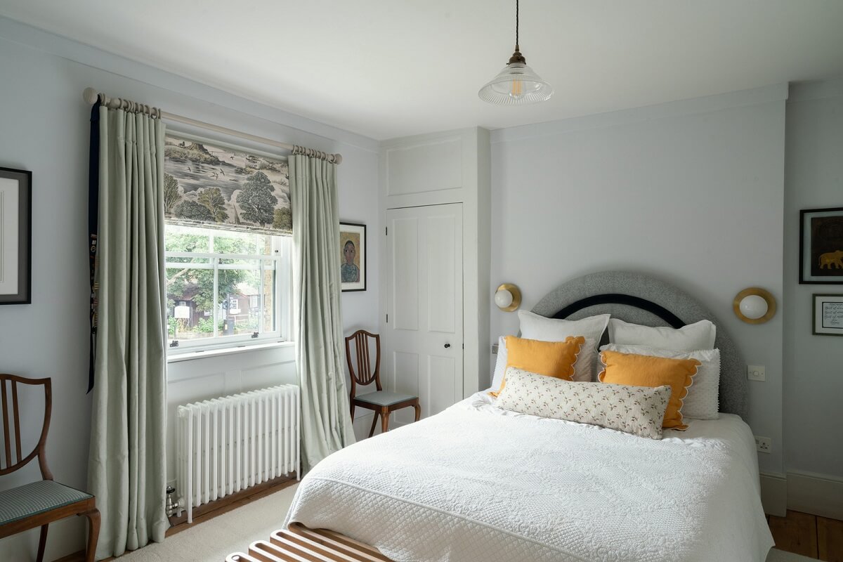 A Beautiful London Family Home with Colorful Accents 17 light gray bedroom with arched headboard