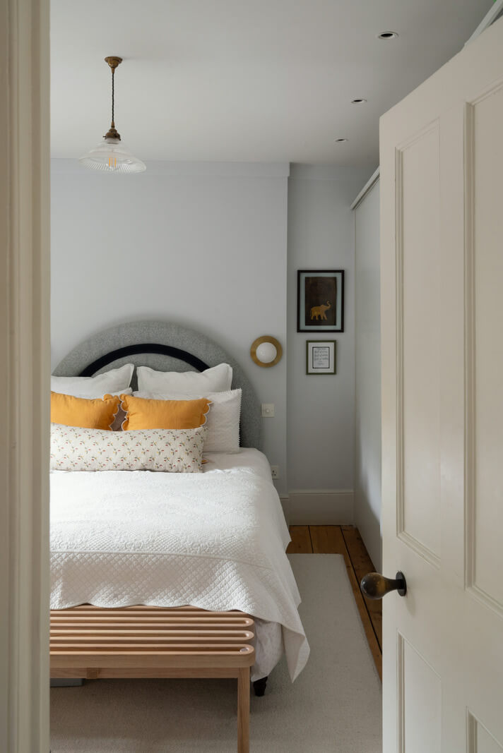 A Beautiful London Family Home with Colorful Accents 18 light gray bedroom with yellow color accent nordroom