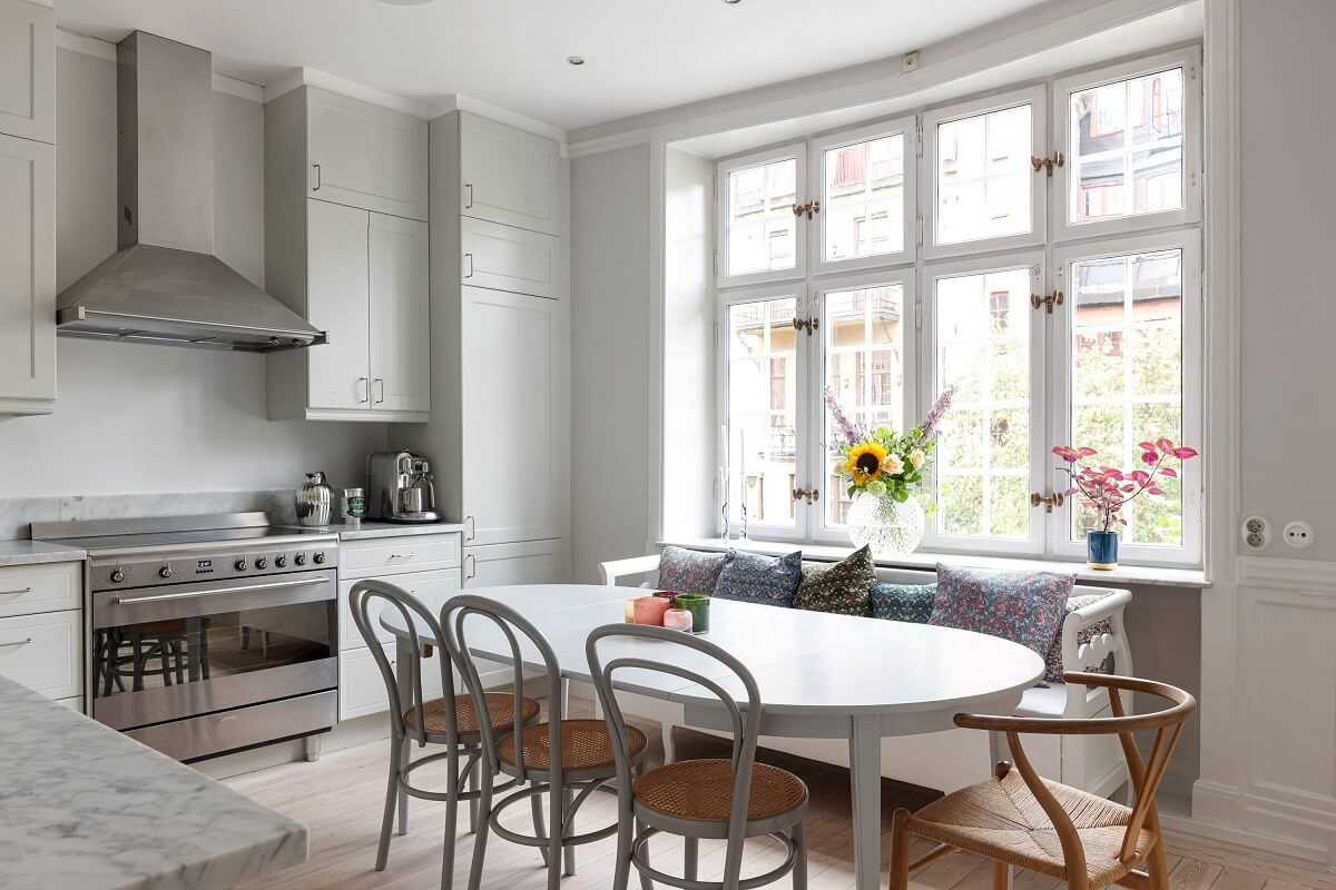A Classic Apartment with a Blue Living Room 18 light gray kitchen with dining table