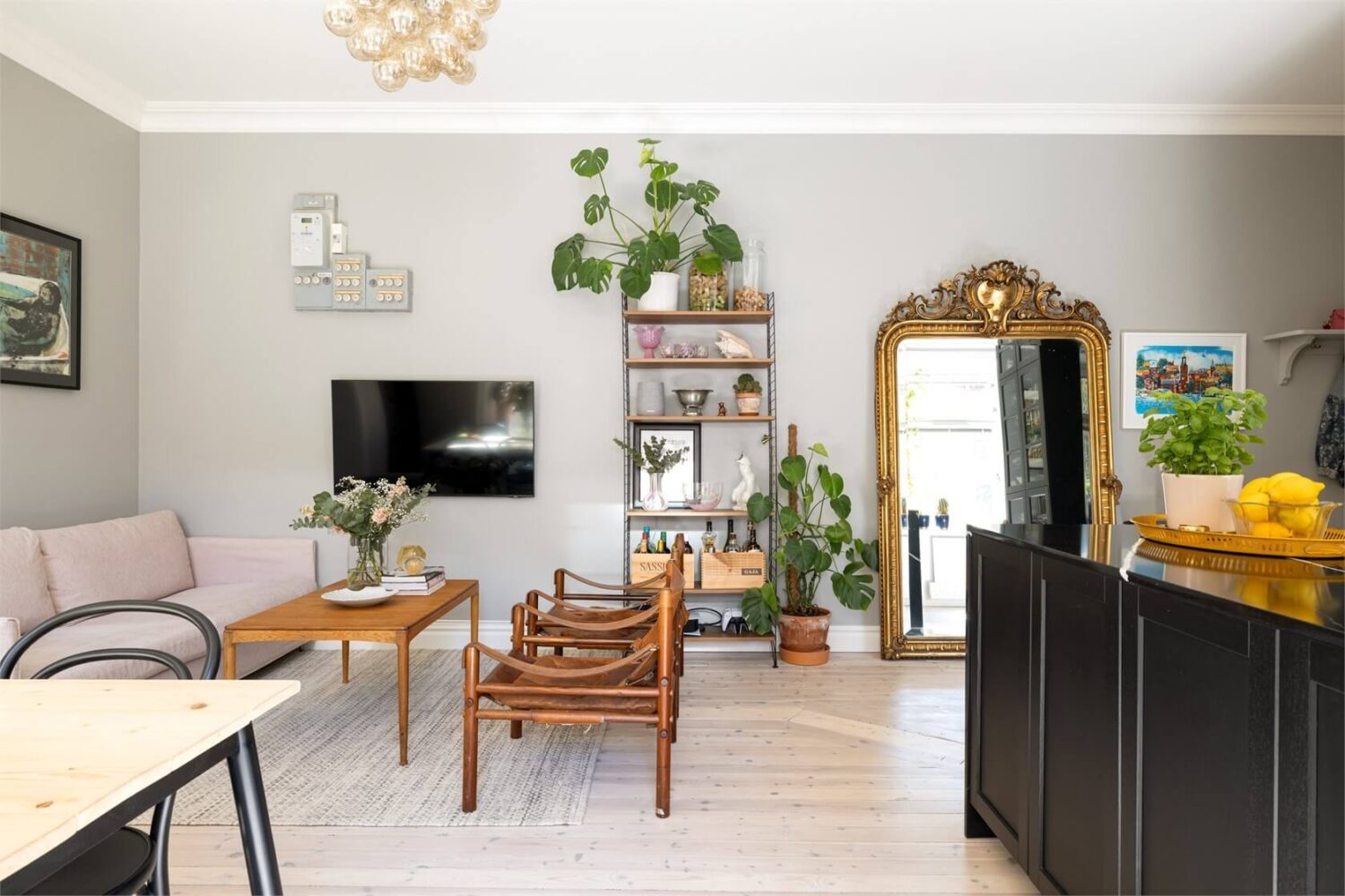 A Lovely Stockholm Apartment with a Black Kitchen and Pink Bedroom 2 light gray walls open plan living room kitchen