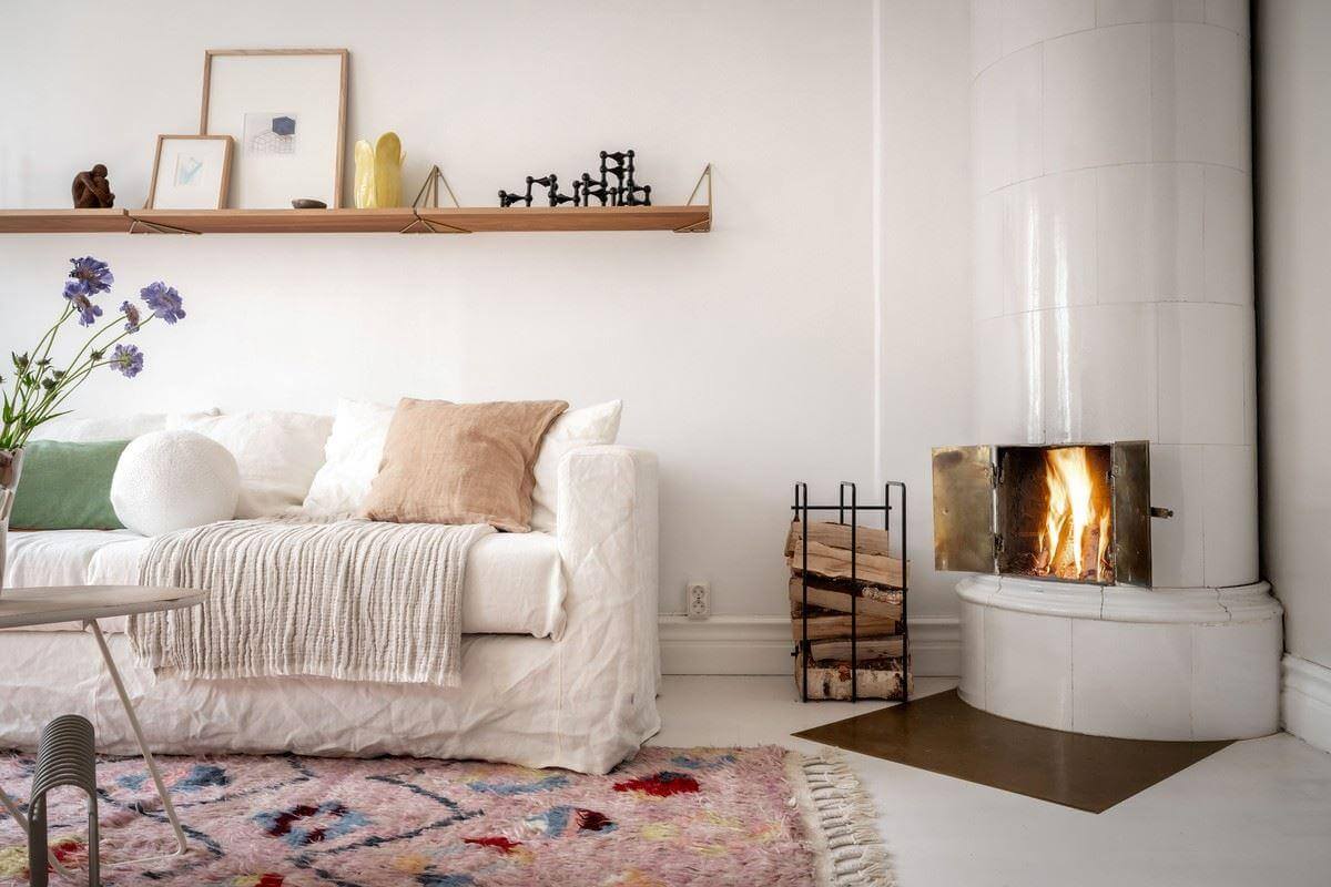 A Bright Swedish Apartment with Subtle Color Accents 3 light living room with fireplace nordroom
