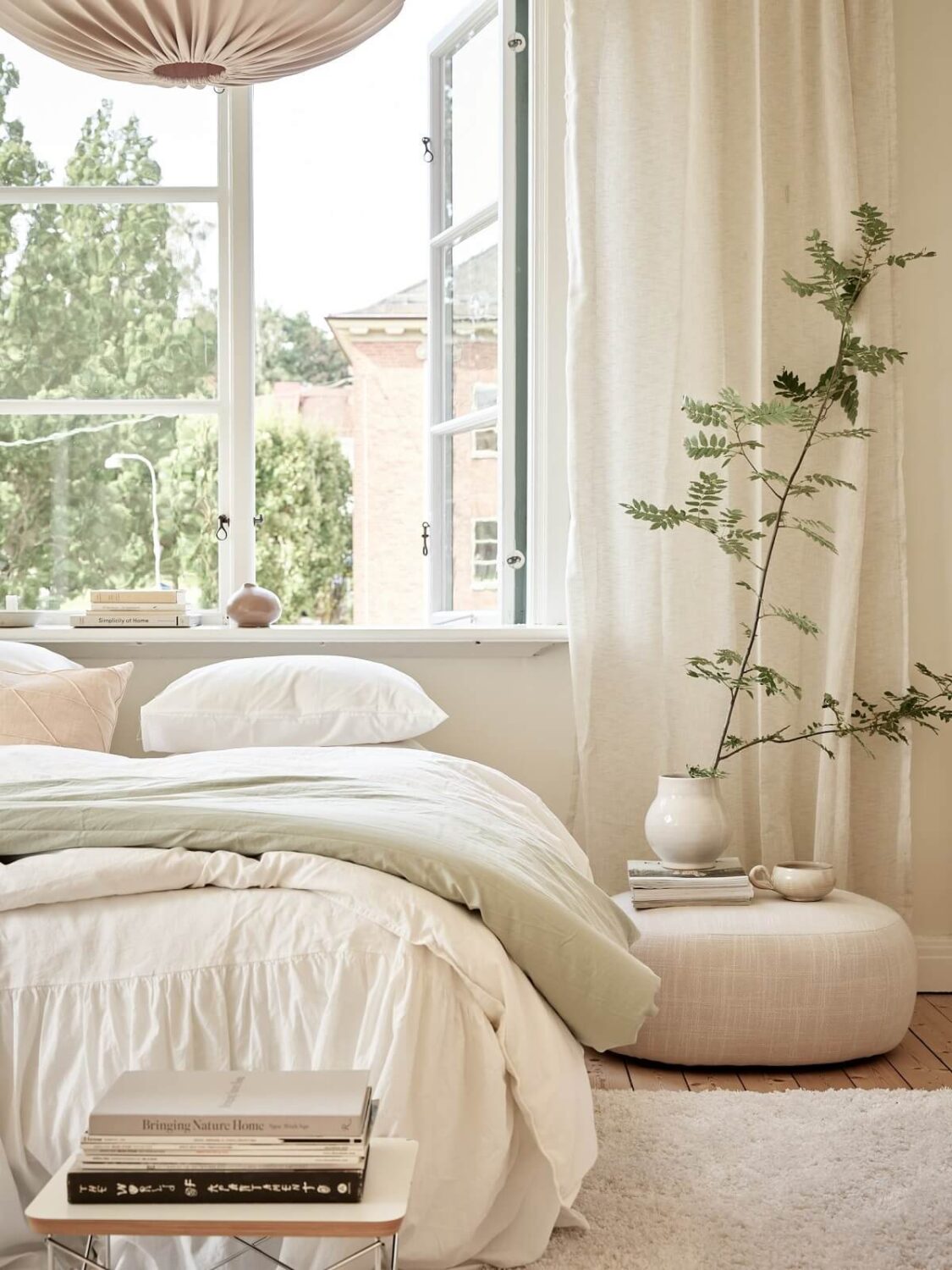A Light Swedish Apartment with a Charming Kitchen 15 light scandinavian bedroom with bed under window nordroom