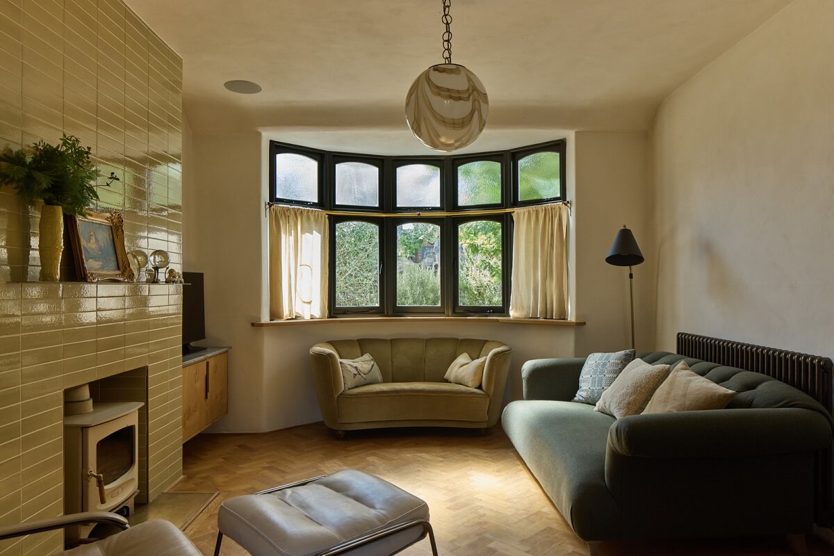 Stained Glass Doors and Terrazzo in a London Home 8 living room lime plaster wayy curved bay window and beige fireplace tiles nordroom