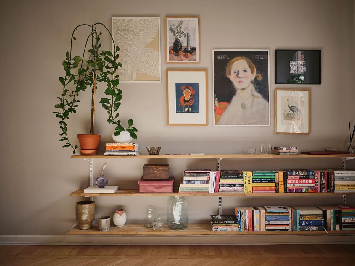 Muted Gray, Green, and Yellow Walls in a Stockholm Apartment 5 living room shelves