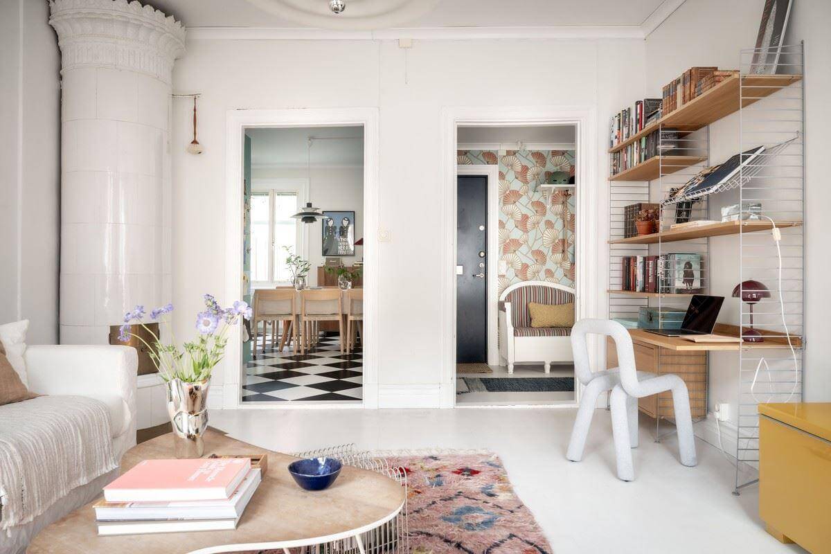 A Bright Swedish Apartment with Subtle Color Accents 8 living room string shelves fireplace