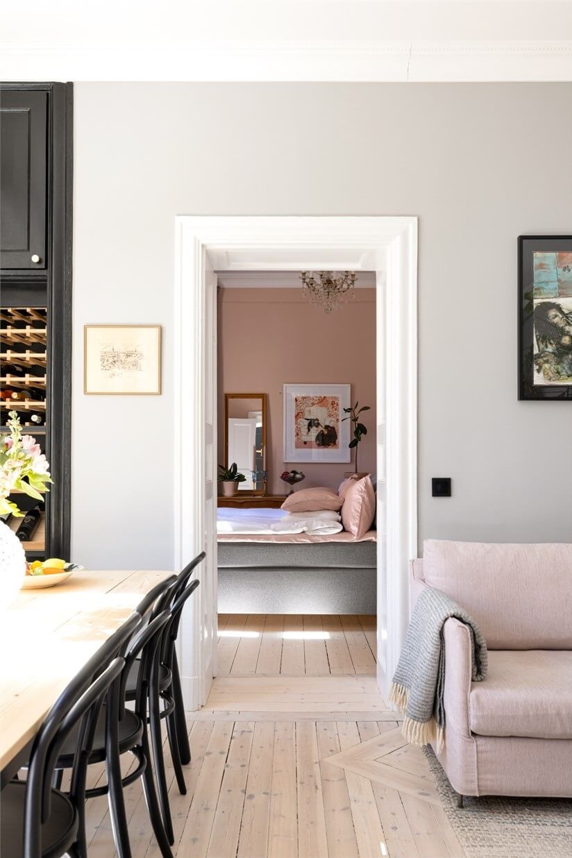 A Lovely Stockholm Apartment with a Black Kitchen and Pink Bedroom 18 living room view into bedroom