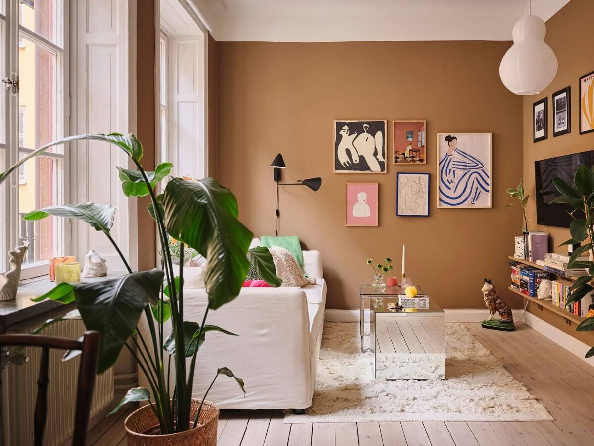 A Small Apartment with Calm Brown, Green, and Yellow Walls 1 living room with brown walls and wooden floor nordroom