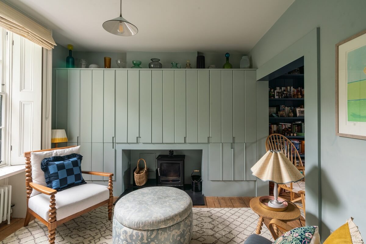 A Beautiful London Family Home with Colorful Accents 2 living room with custom storage cabinets and wood burner nordroom