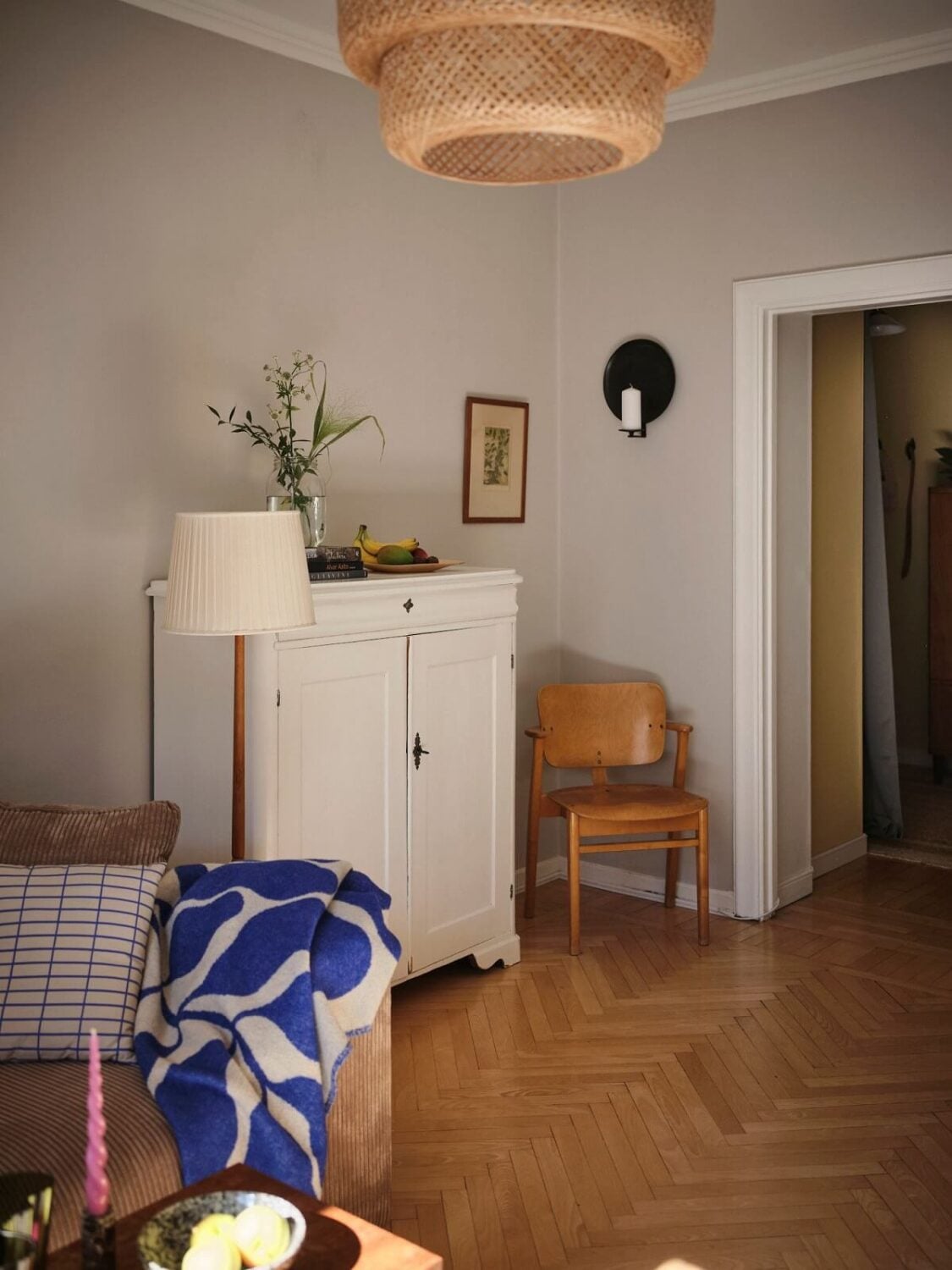 Muted Gray, Green, and Yellow Walls in a Stockholm Apartment 6 living room with gray walls and herringbone parquet